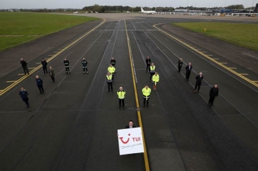 Tees Valley Mayor Ben Houchen and airport staff on the runway revealing the TUI announcement